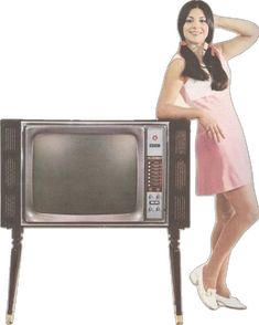 a woman standing next to an old fashioned tv with her hand on her head and arms behind her head