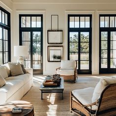 a living room filled with furniture and lots of window paned windows on the wall