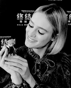 a black and white photo of a woman holding a toy