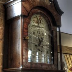 an old wooden grandfather clock with roman numerals