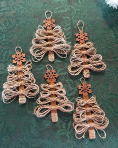 four small christmas trees made out of twine