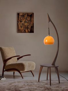 a chair sitting next to a lamp in a room