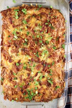 a casserole dish with meat, cheese and green onions