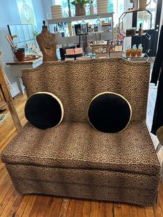 a leopard print chair with two black circles on it