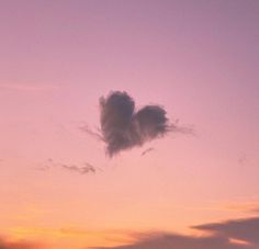 an airplane flying in the sky at sunset