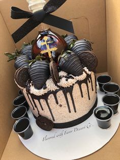 a cake with chocolate covered strawberries in a box