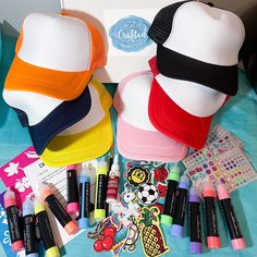 several hats and markers on a table