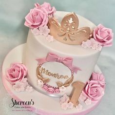 a white cake with pink flowers and butterflies on top