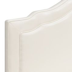 a close up view of a white bed headboard