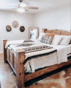 a bed sitting inside of a bedroom next to a ceiling fan