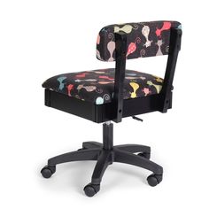 an office chair with mickey mouse fabric on it's back and arms, in front of a white background