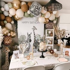 a birthday party with zebras, giraffes and balloons on the wall