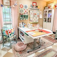 a sewing studio with lots of crafting supplies on the table and rugs around it