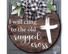 a wooden sign that says i will cling to the old rugged cross on it