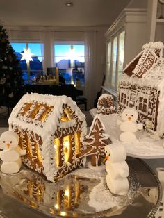 gingerbread houses and snowmen are on display in the living room