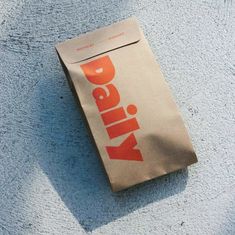 a brown bag sitting on top of a blue towel next to an orange and white object