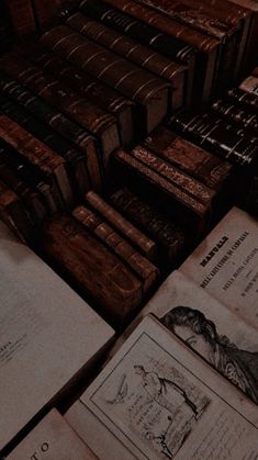 many old books are stacked on top of each other