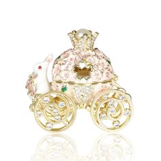 a gold plated carriage with pink and white flowers on the front, surrounded by crystal stones