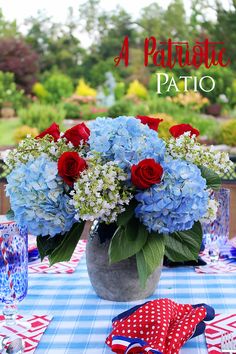 a patriotic table setting with red, white and blue flowers