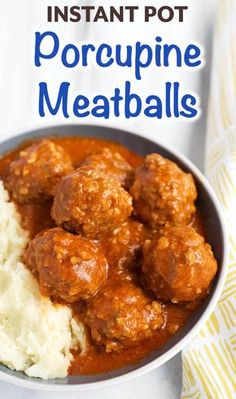 a white bowl filled with meatballs and mashed potatoes on top of a table