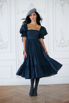 Capture the enchantment of rural France in this high-waist midi dress, boasting a pleated puff skirt and a playfully ruffled hem. Crafted with bows at the sleeve and waistline, and complete with pockets, it's the perfect attire for gathering fresh orchard apples and enjoying wine tasting in the countryside. Pair with the Farmhouse Tartan Duchess Corset to complete the look. Paper cotton midi dress with puff sleeves Double layer pleated puff skirt and ruffled hem Side seam pockets Bow tie detail Christmas Midi Dress, Witchy Wardrobe, Puff Skirt, Rural France, Skirt Swimsuit, Market Dress, Puff Dress, The Farmhouse, Winter Dress