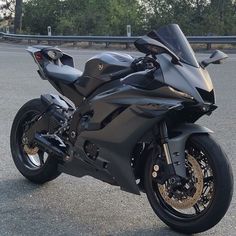 a black motorcycle is parked on the street