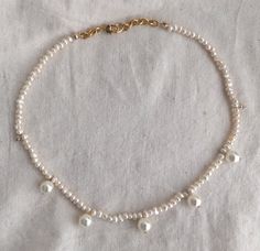 "This is a POP UP PEARL NECKLACE/CHOKER LISTING < - < - < - One of a kind pearl choker necklaces - > - > - > This princess inspired necklace/choker features a gorgeous fresh water Pearls, hand beaded -> 🎁 This Necklace is Perfect for gift giving 🎁 Can wear it layered with gold necklaces or by itself. D E T A I L S - Made with 3mm freshwater pearls. The round hanging pearl are Swarovski pearls size 4-5mm - Hand beaded on white silk thread. - Finished with - 18K Gold Plated Pearl-embellished Choker Necklace For Gifts, Trendy Choker Necklace For Wedding, Trendy Wedding Choker Necklace, Adjustable Pearl-embellished Necklace For Gifts, Adjustable Pearl Embellished Necklace For Gift, Bridesmaid Pearl Necklace, Pearl Necklace Choker, Gold Link Necklace, Bridesmaid Pearls