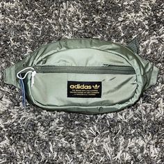 New Adidas Originals National Waist Pack / Crossbody Color: Major, Black, Gold ( Army, Military Green ) Size: Os *Unisex* *Ships Same Day Or Next!!!! *Please Feel Free To Ask Any Questions!!!! Product Details Fabric Type 100% Polyester Care Instructions Hand Wash Only Origin Imported Country Of Origin Indonesia About This Item Branding In Front. Zippered Main Compartment And Small Front Pocket. Key Fob In Front Pocket. Clip-Lock Closure. Metal Pullers. Description Worn Across Your Body Or Around Sporty Streetwear Bags With Pockets, Casual Streetwear Bags With Pockets, Sporty Green Bags For Streetwear, Casual Green Sports Bag, Casual Streetwear Bag With Zipper Closure, Casual Adidas Bag With Zipper Closure, Casual Adidas Bags With Zipper Closure, Casual Adidas Bags For Everyday Use, Adidas Casual Crossbody Bag