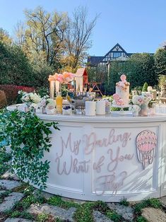 an outdoor bar with flowers and candles on it that says, my birthday is what you eat