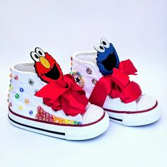 Step into fun with our Sesame Street Converse Shoes, designed to bring joy to every step your little one takes! These stylish white shoes are accented with vibrant red, orange, yellow, green, and blue pearls, creating a colorful and playful look. The toe is adorned with elegant white pearls, adding a touch of sparkle. But the real magic lies in the tongue of the shoe, where beloved characters Cookie Monster and Elmo peek out as adorable patches, adding a playful surprise. Perfect for any Sesame Cookie Monster And Elmo, Converse Custom, Blue Pearls, Real Magic, Red Orange Yellow, Blue Pearl, Cookie Monster, Monster Cookies, Green And Blue