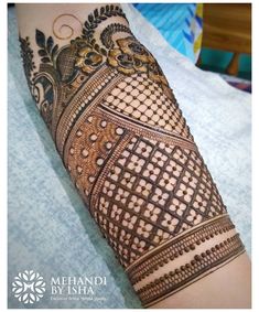 a woman's arm with henna tattoos on it