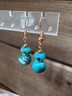 Adorn yourself with these breathtaking Turquoise Beaded Dangle Earrings, a splendid example of boho chic jewelry. Handcrafted with care, these earrings embody the essence of Southwest style, exuding a free-spirited charm. The vibrant turquoise beads add a pop of color and personality to any outfit, making them a versatile accessory for everyday wear or special occasions. Each pair is a unique piece of handmade jewelry, showcasing the artisan's dedication to detail and creativity. Elevate your style with these dangle earrings that capture the essence of bohemian flair and artistic elegance.  Check out the matching necklace and bracelets. Bohemian Blue Beaded Earrings With Natural Stones, Turquoise Wire Wrapped Beaded Earrings, Turquoise Earrings With Dangling Beads For Gift, Adjustable Artisan Turquoise Beaded Earrings, Turquoise Beaded Drop Earrings, Bohemian Turquoise Beaded Round Earrings, Turquoise Jewelry With Dangling Round Beads, Turquoise Beaded Earrings With Natural Stones, Turquoise Wire Wrapped Beaded Earrings As Gift