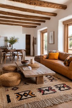 a living room filled with furniture and wooden beams