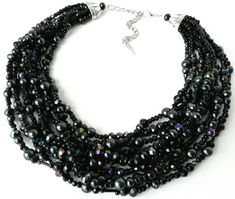 8 strands of black glass pearls are weaved together with sparkling aurora borealis black crystals and bugle beads in this stunning mid-century/vintage style piece.It's everything you need in a black statement necklace, with a pop of sparkling color to create the perfect elegant evening jewelry.Measurements: Approximately 17 inches with a 3 inch extender chain. Length can be adjusted upon request. Thank you for visiting my shop! Please feel free to message me with any questions, comments or custo Multi-strand Beaded Necklace For Evening, Multi-strand Beaded Necklaces For Evening, Beaded Multi-strand Necklace For Evening, Glamorous Black Beaded Jewelry, Costume Jewelry Beaded Necklace With Round Beads For Evening, Evening Costume Jewelry With Round Beaded Necklaces, Black Multi-strand Jewelry For Evening, Black Multi-strand Beaded Necklace For Evening, Multi-strand Black Beaded Necklace For Evening