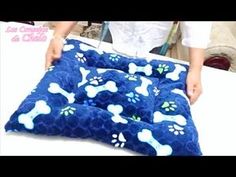 someone is making a dog bed with blue and white paw prints