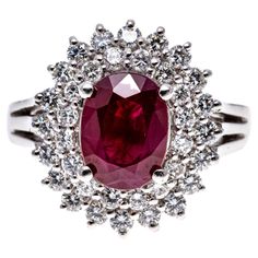 Platinum ring. This classically beautiful ring is a cocktail style, with a faceted oval shape, dark red color ruby center stone, prong set, and approximately 1.11 CTS. Surrounding the stone is a double halo of round faceted cut diamonds, approximately 0.64 TCW, and also prong set. The ring is further decorated with a triple shank. Marks: Pt 900 Dimensions: 9/16" long x 5/8" wide Weight: 7.8 gross dwt Dark Red Color, Double Diamond, Golden Ring, Swag Outfits For Girls, Double Halo, Beautiful Engagement Rings, Lorde, Platinum Ring, Ruby Diamond