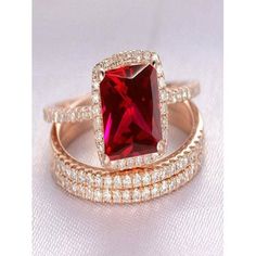 a red diamond ring set on top of each other with diamonds around the band and in between