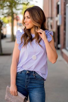 Everything looks better with ruffles! The pleated ruffle trim accents and cinched neckline on this tank sets it apart from the rest! Tuck into your favorite high-waisted shorts or patterned skirt for those hot sunny days or use as a layering piece with your favorite cardigan or shacket for the cooler ones! Tshirt Under Dress, Spring Lavender Ruffled Blouse, Trendy Lavender Ruffled Top, Ruffle Shirt Outfit, Feminine Lavender Tops With Ruffles, Purple Ruffle Sleeve Spring Top, Sleeveless Lavender Ruffled Top, Patterned Skirt, Summer Palette