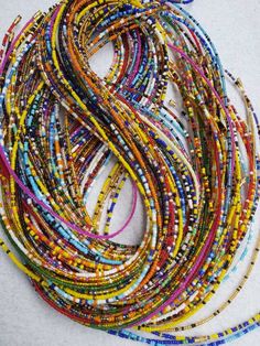 This is a set of 50 discounted waist beads all in different colours. The set is all made using small beads mixtures and a few plain colours. All the waist beads are non-strech and cannot be adjusted to a shorter or longer length. They are easiy to put on and off . These waistbeads look nice on the waist and can be used as waist belts too. They help shape the waist and in tracking weight loss. You can request for different sizes after purchase and more than 50 waist beads too. Shipping is fast an Colorful Heishi Waist Beads, Gift Polished Multicolor Waist Beads, Multicolor Beaded Chain Waist Beads, Multicolor Round Beaded Chain Waist Beads, Multicolor Polished Waist Beads, Multicolor Polished Round Waist Beads, Bohemian Multicolor Polished Waist Beads, Beads Waist, African Waist Beads