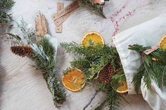 an arrangement of oranges and pine cones on a table