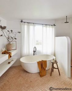 a white bath tub sitting next to a window