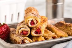 some strawberries and pastries in a metal pan