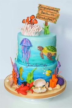 there is a blue cake with an ocean theme on the top and under it are sea animals