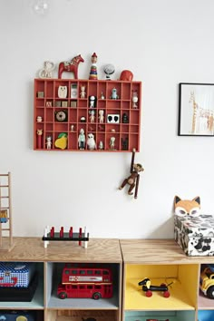 children's playroom with toy shelves and toys on the wall, including a firetruck