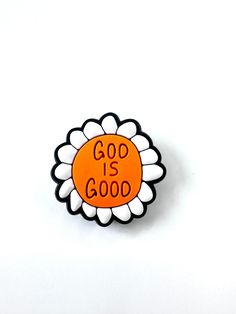 an orange and white flower with the words god is good on it's center