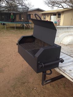 an outdoor bbq grill sitting on top of a trailer