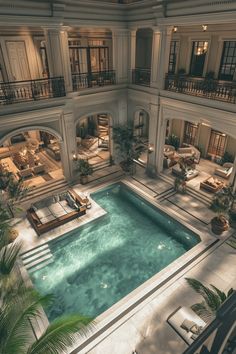 an aerial view of a pool in the middle of a large building with multiple balconies