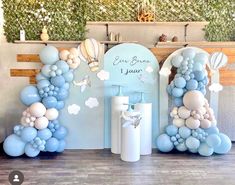 balloons and decorations are arranged in the shape of letters for a baby's first birthday party