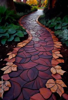 a pathway made out of stones with leaves painted on the path and trees in the background