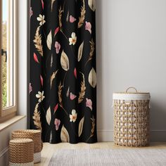 a room with a rug, basket and curtain in front of the window that has an image of flowers on it